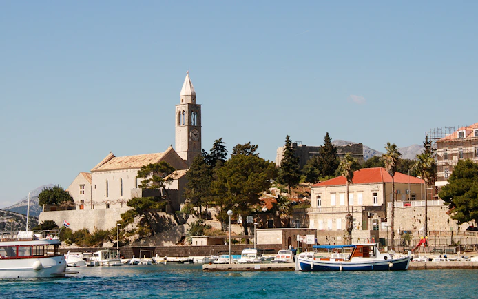 Dubrovnik port view with boats and historic buildings during Blue Cave Swim Stop tour.
