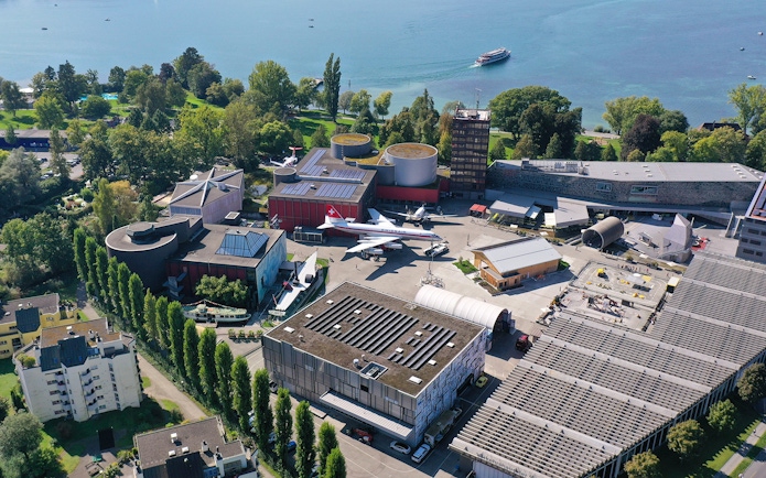 Aerial view of Swiss Museum of Transport in Lucerne with surrounding landscape.