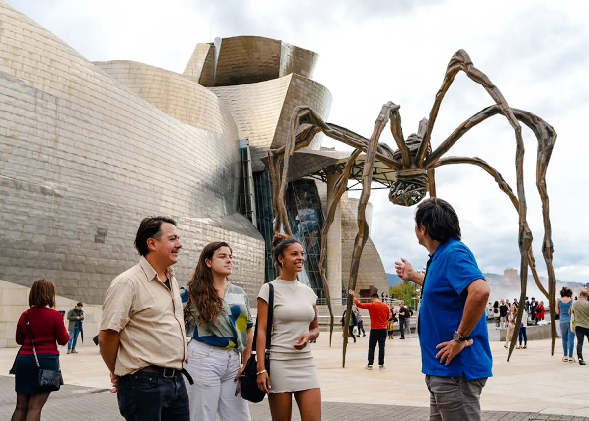 Visitors at Guggenheim Museum Bilbao with Louise Bourgeois' spider sculpture.