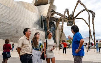 Visitors at Guggenheim Museum Bilbao with Louise Bourgeois' spider sculpture.