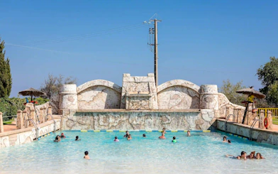 Visitors enjoying the pool at Aqualand Algarve's surf beach.