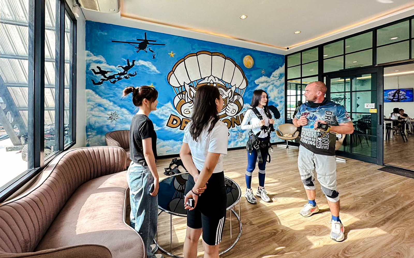 Tourists preparing for Ocean View Tandem Skydive in Pattaya waiting area.