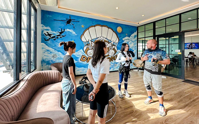 Tourists preparing for Ocean View Tandem Skydive in Pattaya waiting area.