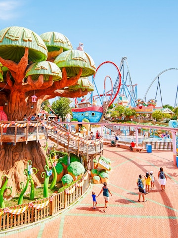 Panoramic view of PortAventura park with colorful rides and themed attractions.
