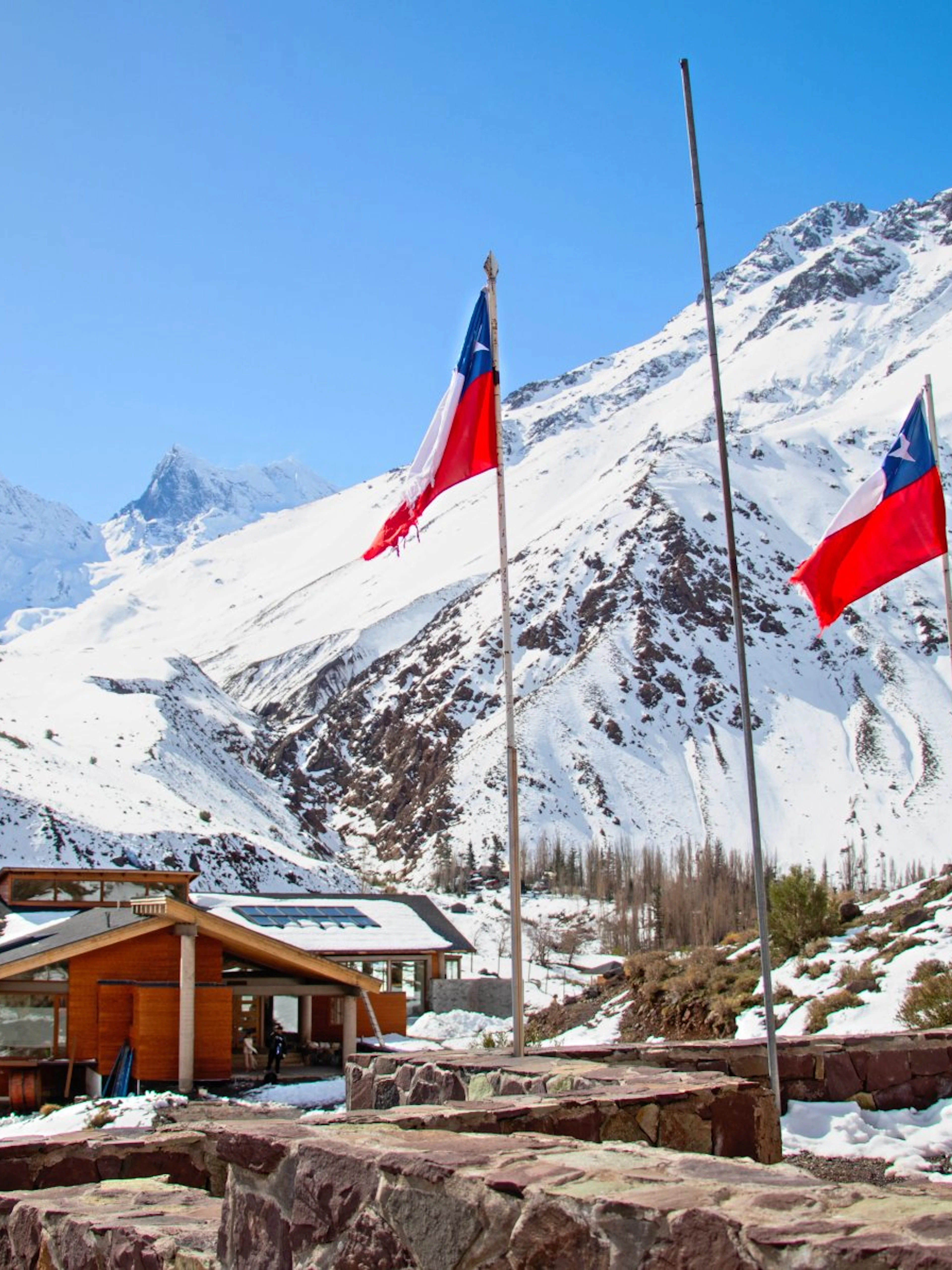Lodge El Morado in the Andes Mountains, Cajón del Maipo, Chile, with snow-covered peaks.