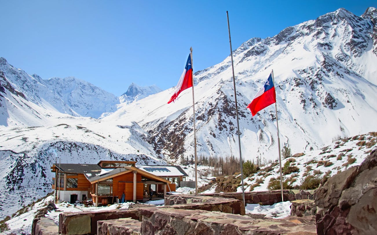 Lodge El Morado in the Andes Mountains, Cajón del Maipo, Chile, with snow-covered peaks.