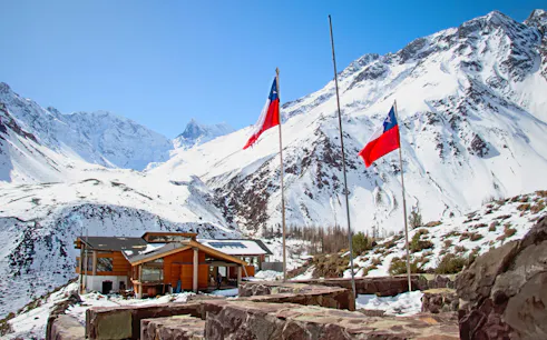 Lodge El Morado in the Andes Mountains, Cajón del Maipo, Chile, with snow-covered peaks.