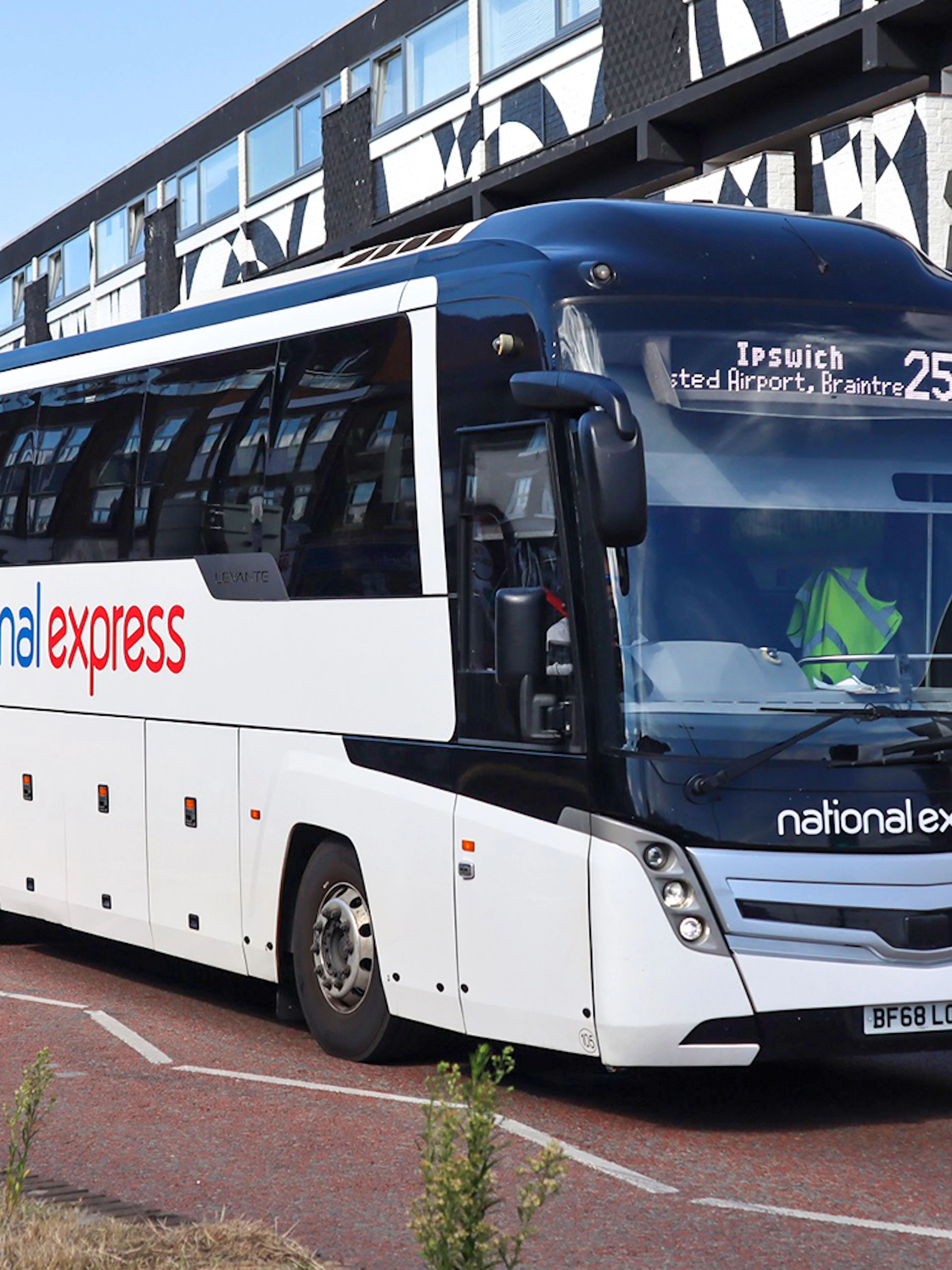 Direct bus to Windsor Castle from Central London on a city street.