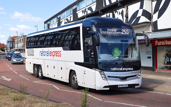 Direct bus to Windsor Castle from Central London on a city street.