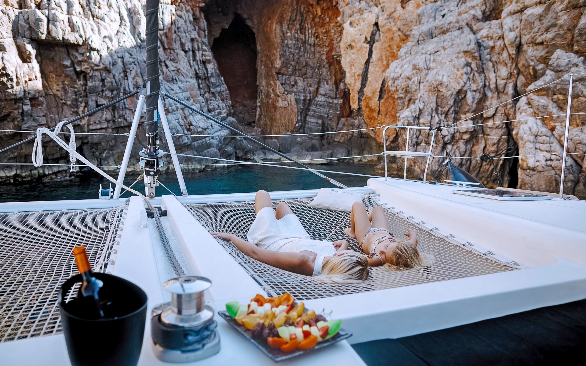 Lounging on catamaran nets near Barbarossa Cave, Spinalonga, Crete.