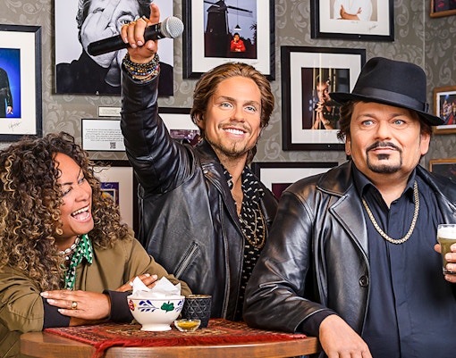 Wax figure of Andre Hazes holding a microphone at Madame Tussauds Amsterdam.