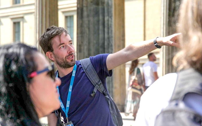 Guide explaining history during Berlin World War II walking tour.