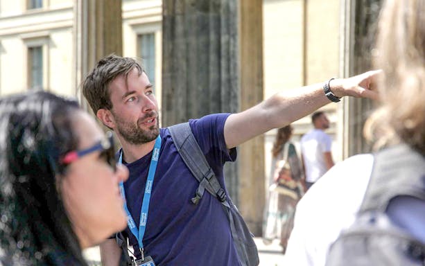 Male guide explaining World War II history during Berlin walking tour.