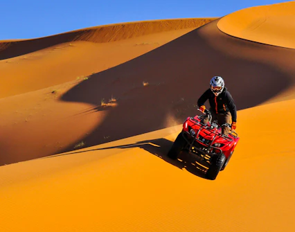 Quad biking on sand dunes during Dubai Desert Safari.