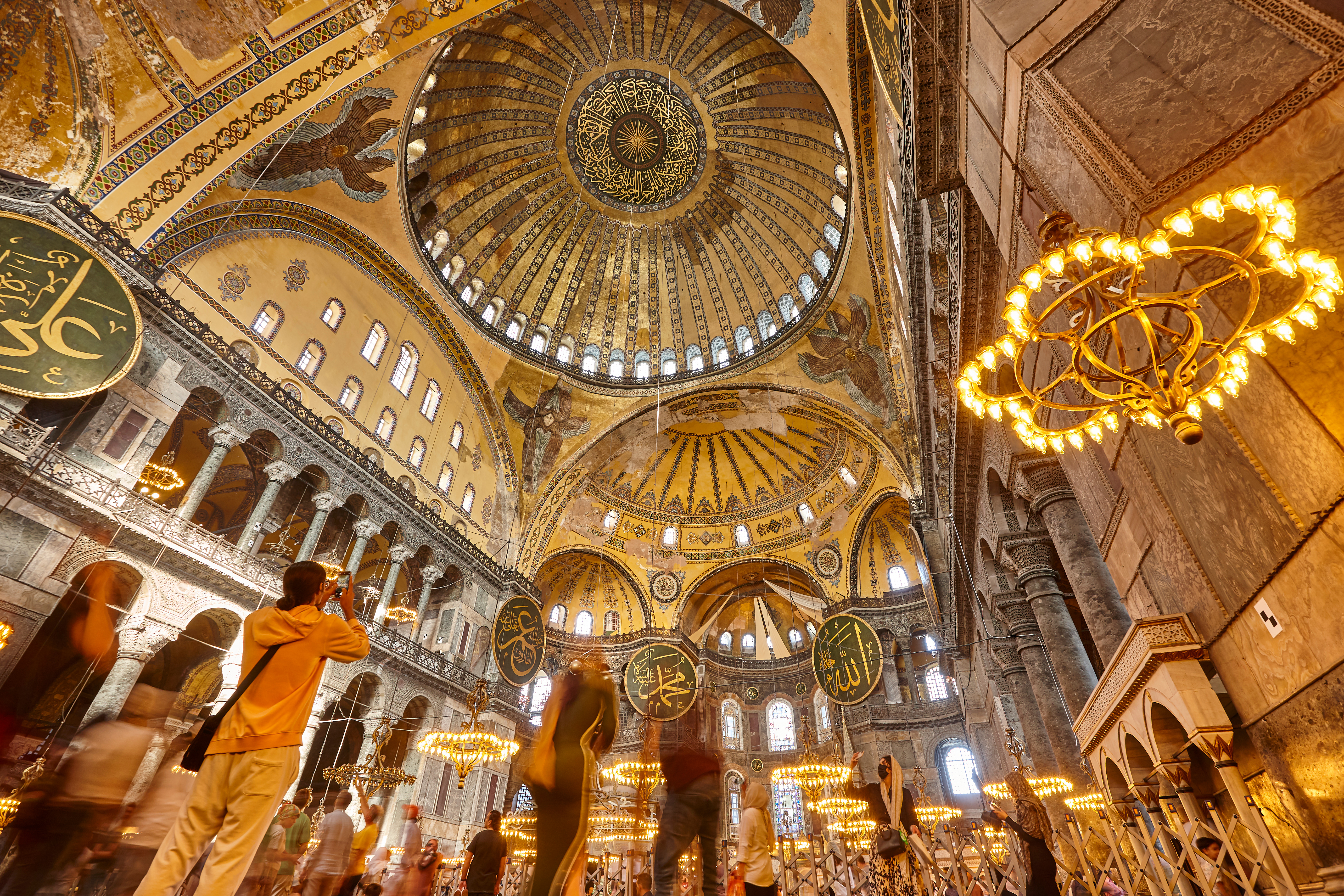Interior view of Hagia Sophia's ornate dome and chandeliers, Istanbul.
