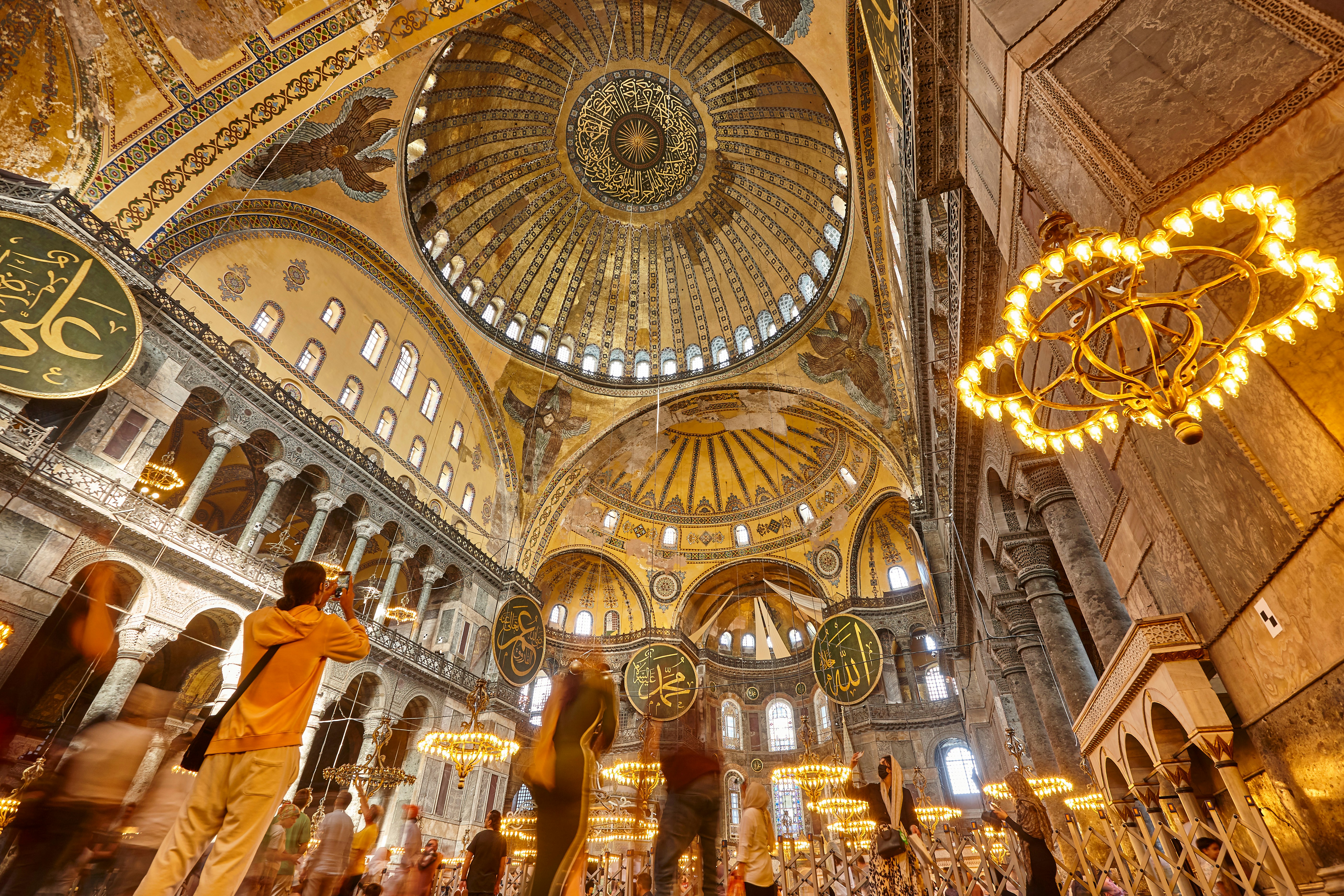 Interior view of Hagia Sophia's ornate dome and chandeliers, Istanbul.