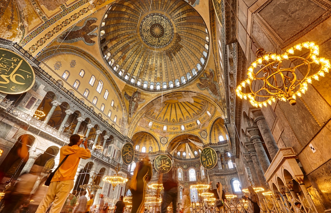 Interior view of Hagia Sophia's ornate dome and chandeliers, Istanbul.