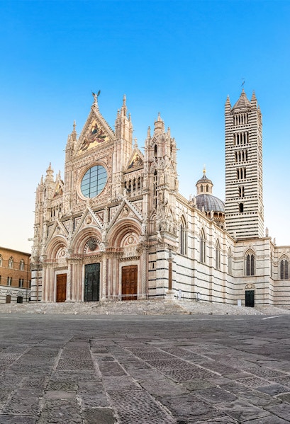 Siena Cathedral exterior with intricate Gothic architecture in Siena, Italy.