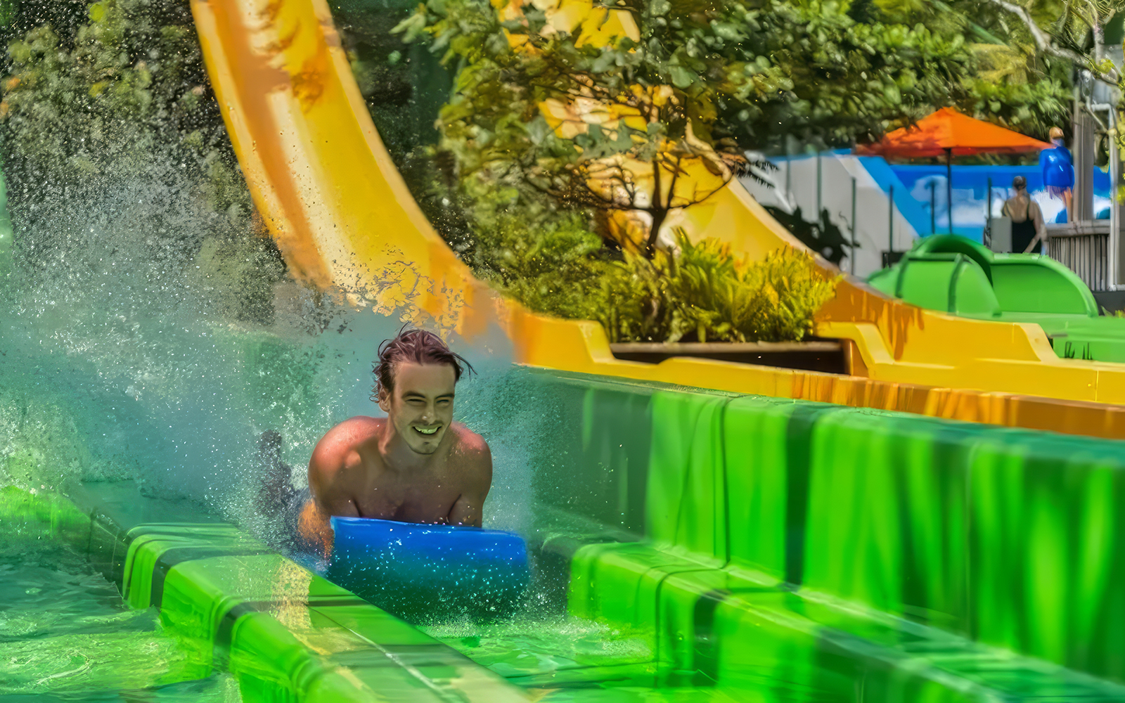 Man sliding down a water slide at Waterbom Bali, Indonesia.