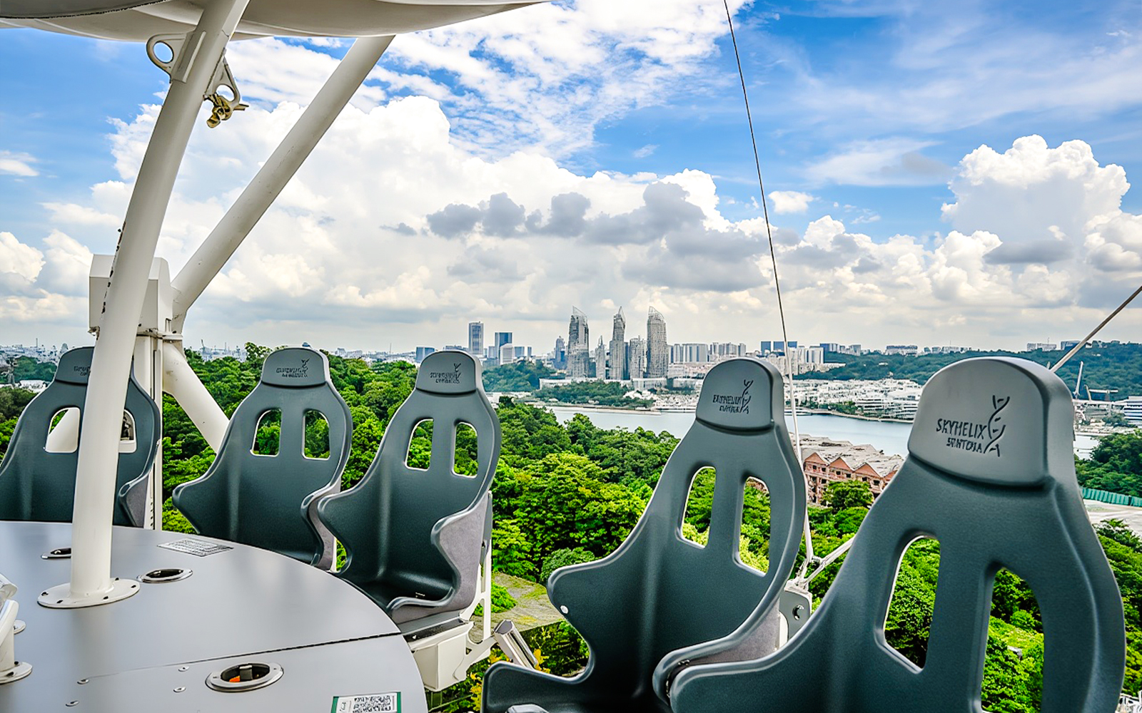 Skyhelix Sentosa ride with panoramic view of Singapore skyline and lush greenery.