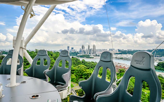 Skyhelix Sentosa ride with panoramic view of Singapore skyline and lush greenery.