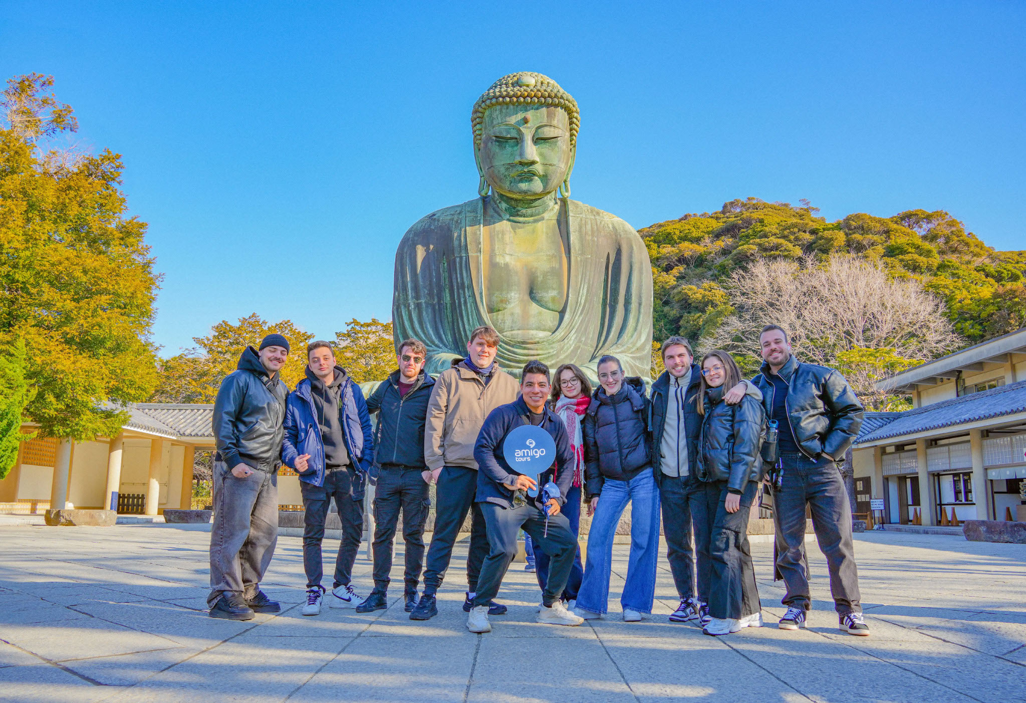Group of tourists in front of the Great Buddha of Kamakura, Japan.