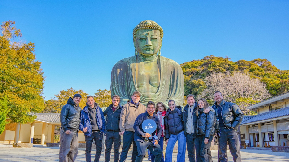 Group of tourists in front of the Great Buddha of Kamakura, Japan.