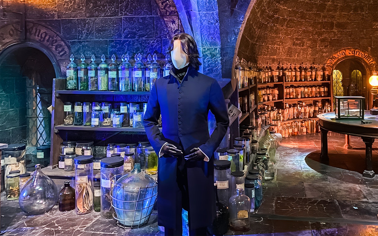 Mannequin in wizard costume at potion room, Harry Potter London tour exhibit.