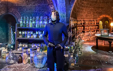 Mannequin in wizard costume at potion room, Harry Potter London tour exhibit.