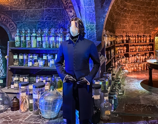 Mannequin in wizard costume at potion room, Harry Potter London tour exhibit.