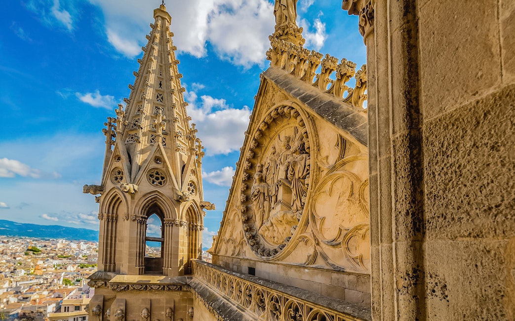 Cathedral of Majorca terrace view with intricate stone carvings and cityscape.