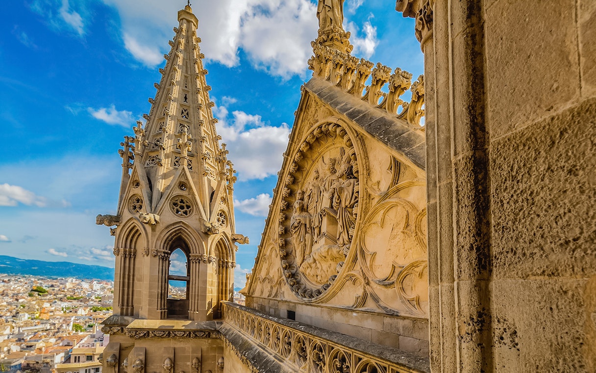 Cathedral of Majorca terrace view with intricate stone carvings and cityscape.