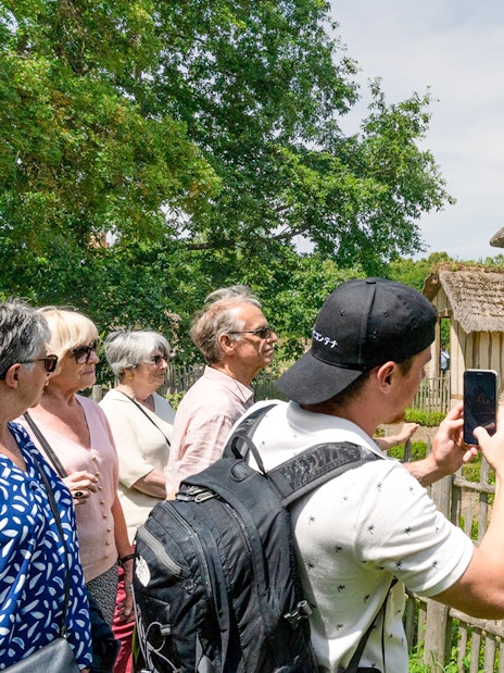 Tourists viewing a rustic cottage in the Domain of Marie-Antoinette, Versailles.