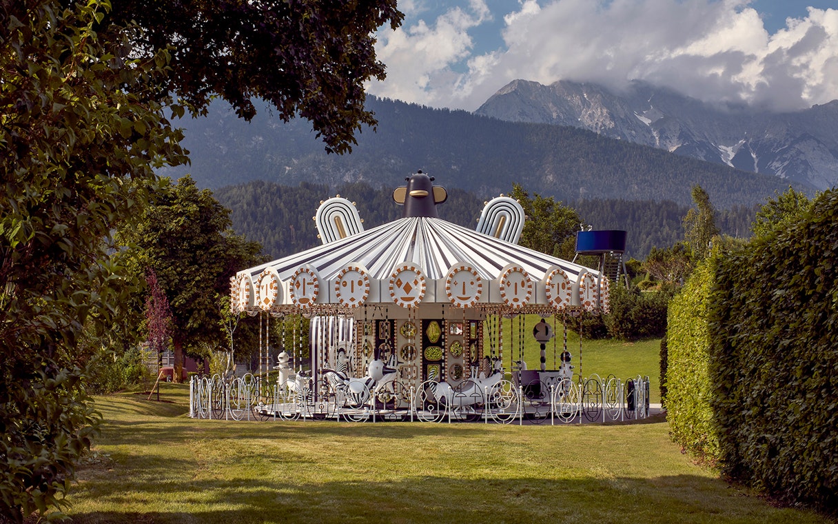Carousel at Swarovski Crystal Worlds with mountain backdrop, Wattens, Austria.