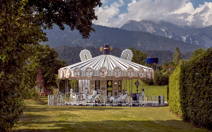 Carousel at Swarovski Crystal Worlds with mountain backdrop, Wattens, Austria.