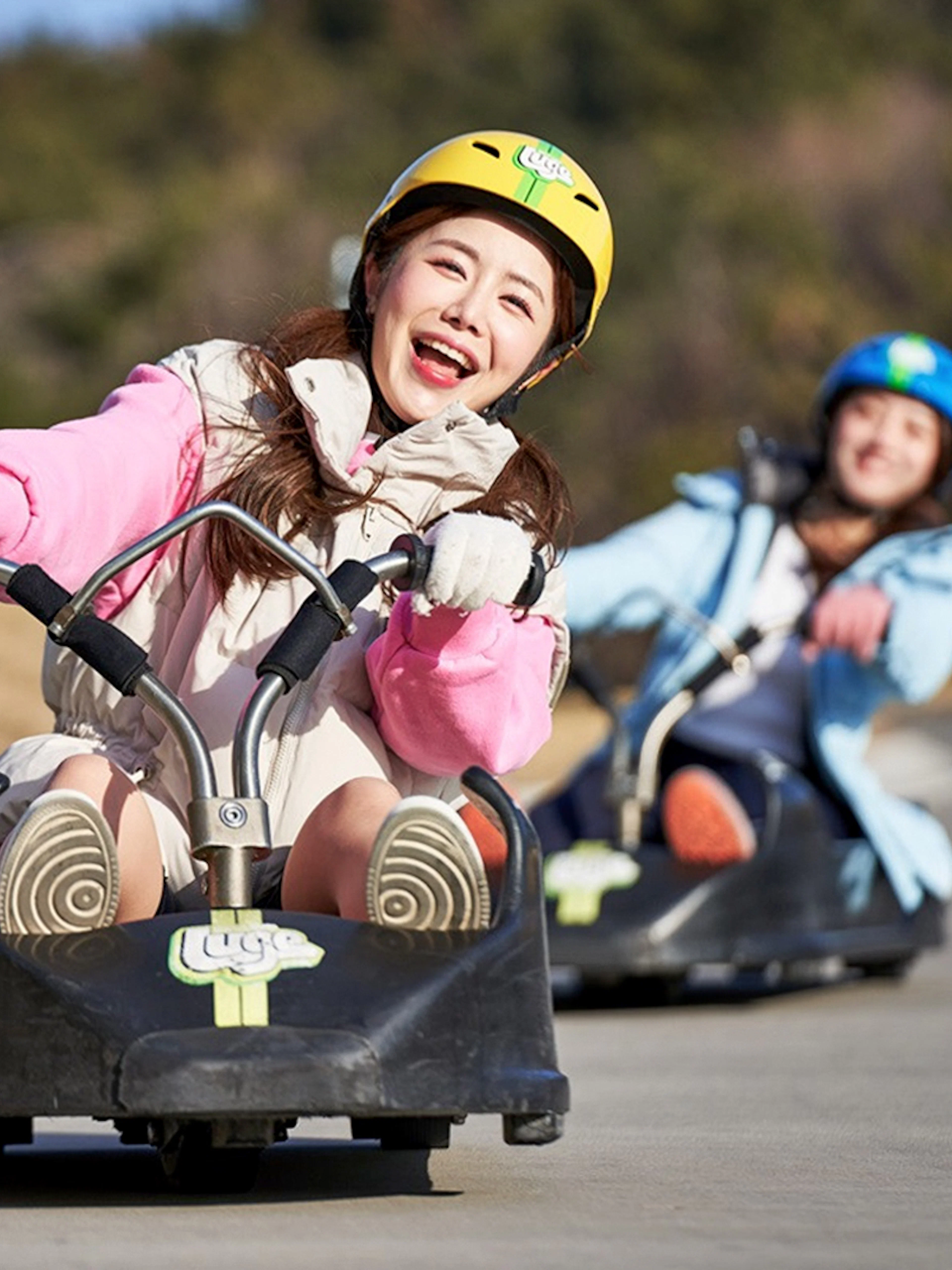 People enjoying a luge ride at Skyline Luge Busan.