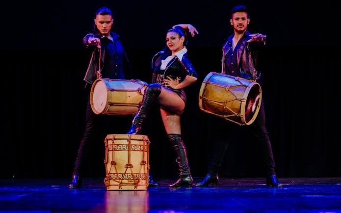 Tango artists performing with drums at Tango Porteño Show in Buenos Aires.