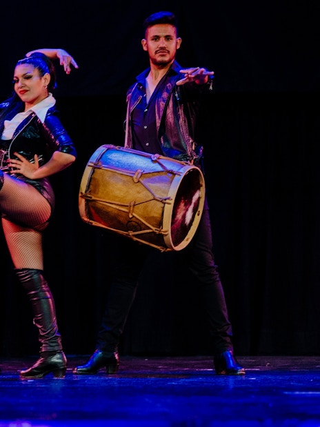 Tango artists performing with drums at Tango Porteño Show in Buenos Aires.