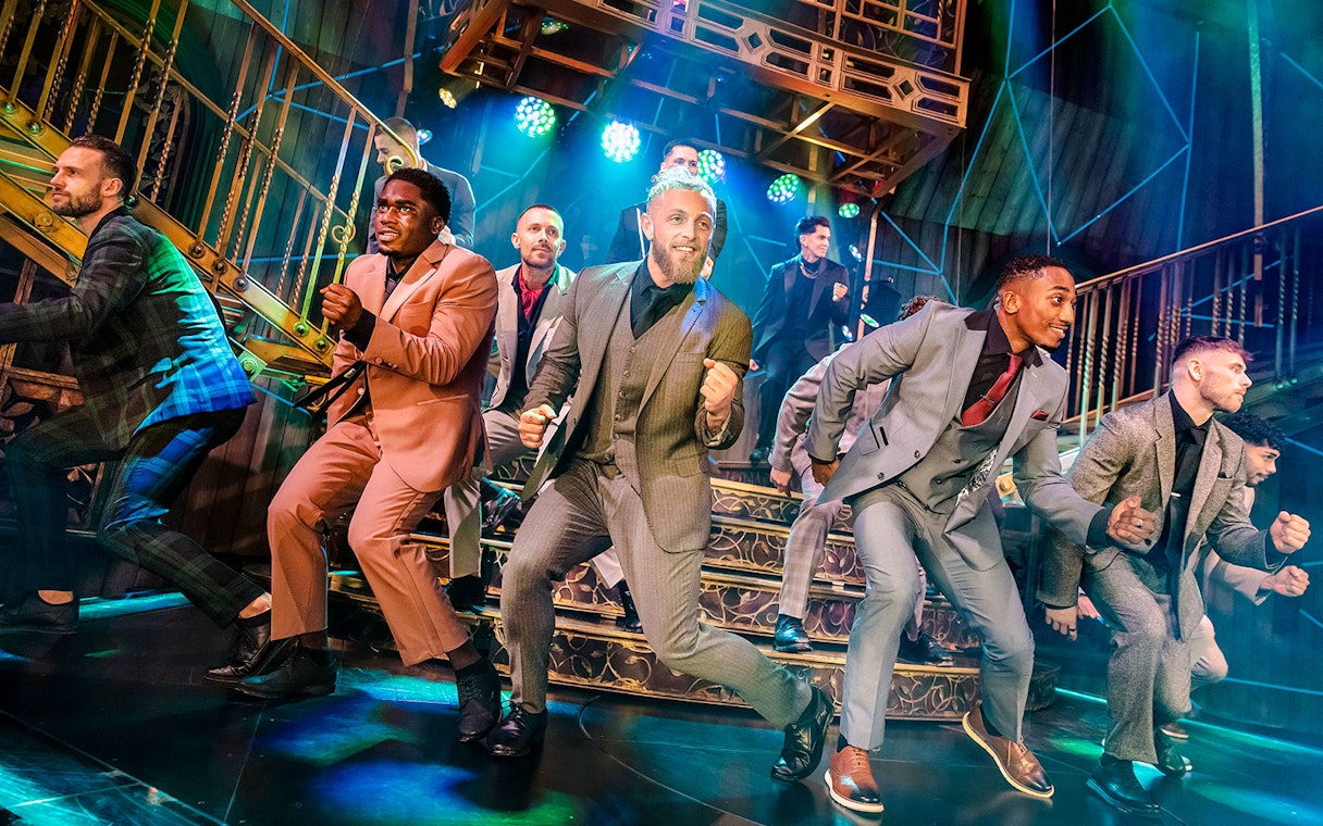 Performers dancing energetically on stage during Magic Mike Live show.