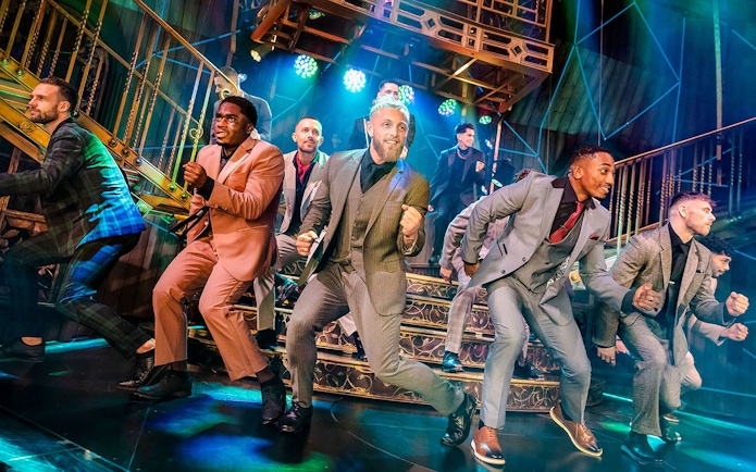 Performers dancing energetically on stage during Magic Mike Live show.