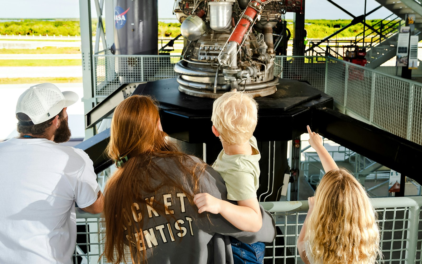 Family observing rocket engine at Gantry LC-39, Kennedy Space Center.