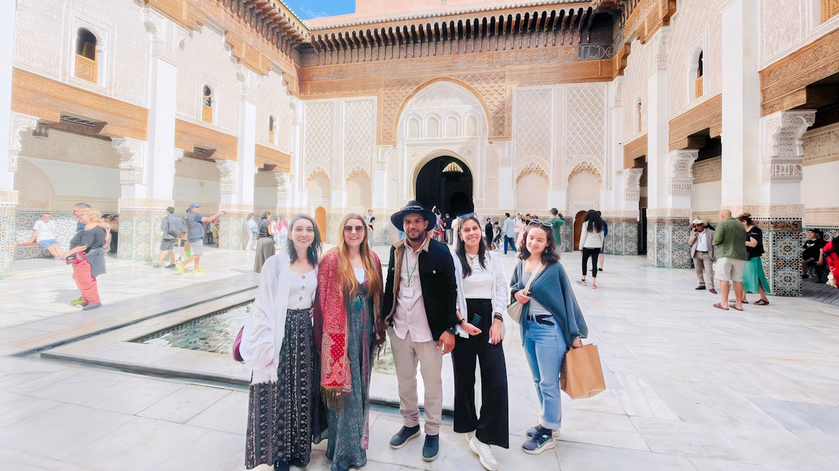 Group with guide at Ben Youssef Madrasa courtyard in Marrakech, Morocco.