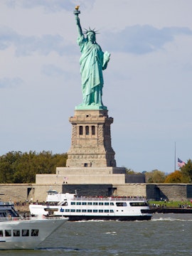 Cruise ship passing by the Statue of Liberty in New York.