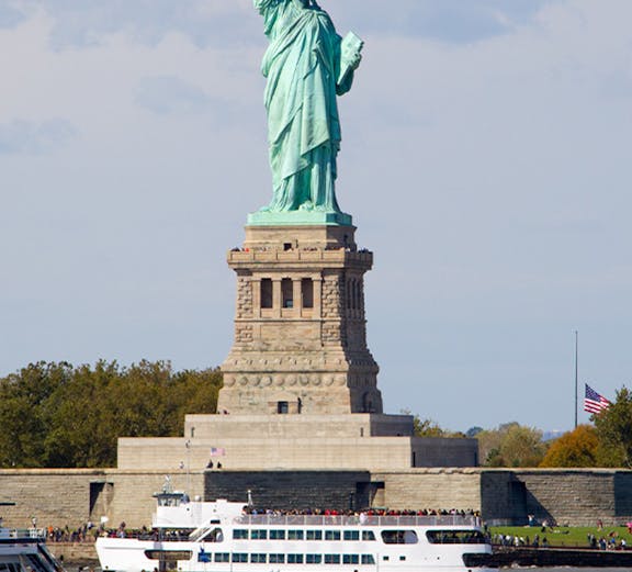 Cruise ship passing by the Statue of Liberty in New York.