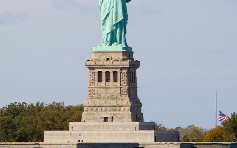 Cruise ship passing by the Statue of Liberty in New York.