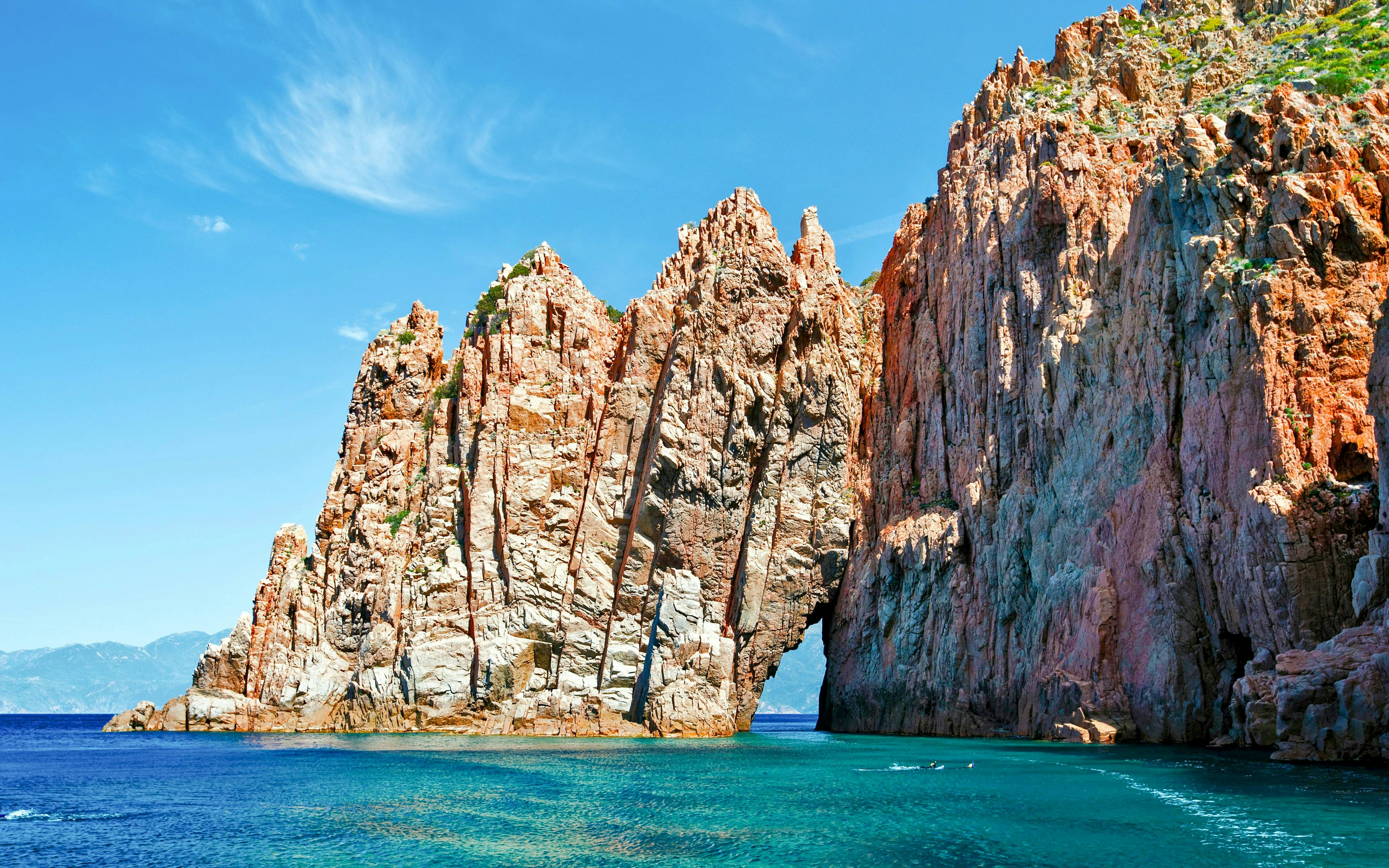 Rocky cliffs of Frioul Archipelago with clear blue sea, part of Châteaux d’if Exploration Sailing.