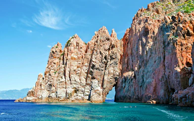 Rocky cliffs of Frioul Archipelago with clear blue sea, part of Châteaux d’if Exploration Sailing.