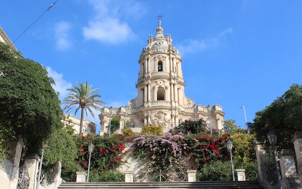 Baroque cathedral in Modica with floral gardens, part of Minivan Tour from Siracusa.