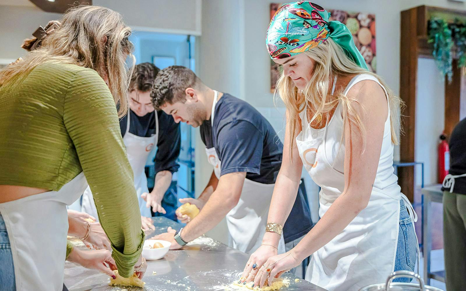 Participants kneading dough in a small group cooking class in Florence.