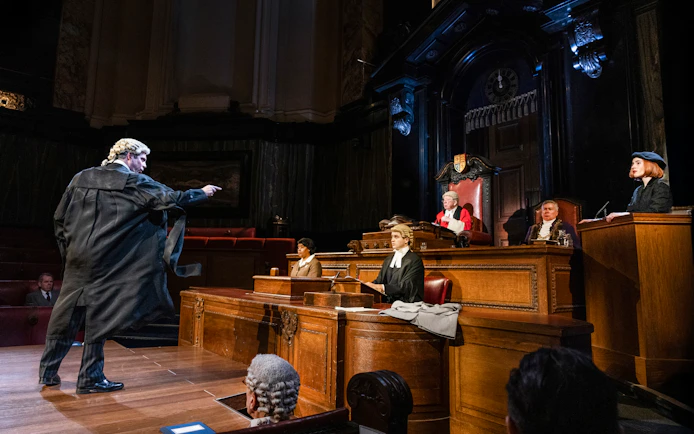 Courtroom scene from "Witness for the Prosecution" performance with actors in period costumes.